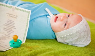 Baby with certificate of birth clipart