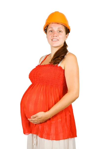 Kobieta w kask trzyma ciąży brzuch — Zdjęcie stockowe