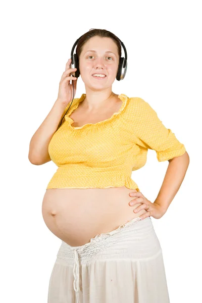 Terhes nő fülhallgatóval — Stock Fotó