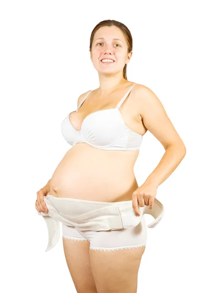 Έγκυος γυναίκα φοράει μαιευτική συνδετικό υλικό — Φωτογραφία Αρχείου