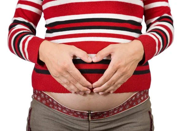 Schwangerschaftsbauch mit Herz aus Händen — Stockfoto