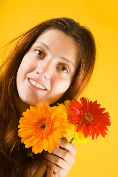 Girl with flowers on yellow — Stock Photo, Image