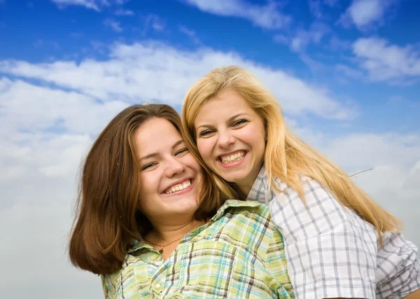 Happy girls against cloudy sky — Stock Photo, Image