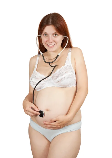 Těhotná žena poslechu břicho — Stock fotografie