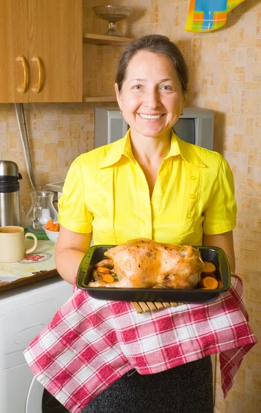 Mulher com frango cozido — Fotografia de Stock