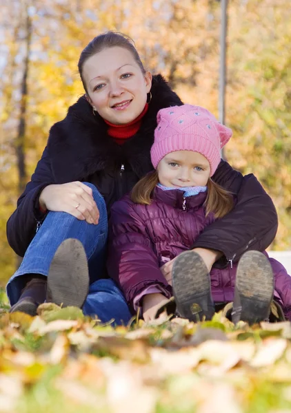 Woman with girl in autumn — Stock Photo, Image