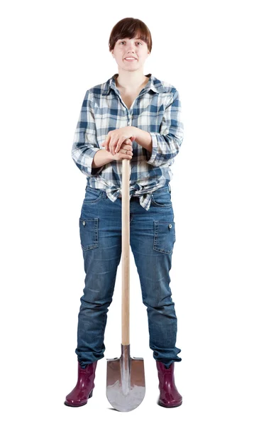 Vrouw stands met spade — Stockfoto
