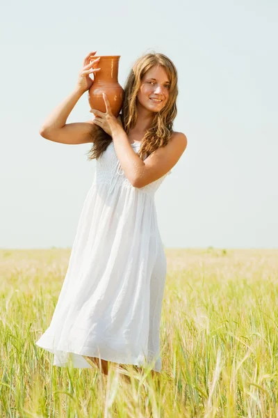 Girl with jug at field — Stock Photo, Image