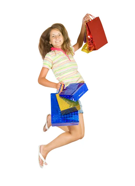 Прыгающая девушка с сумками — стоковое фото