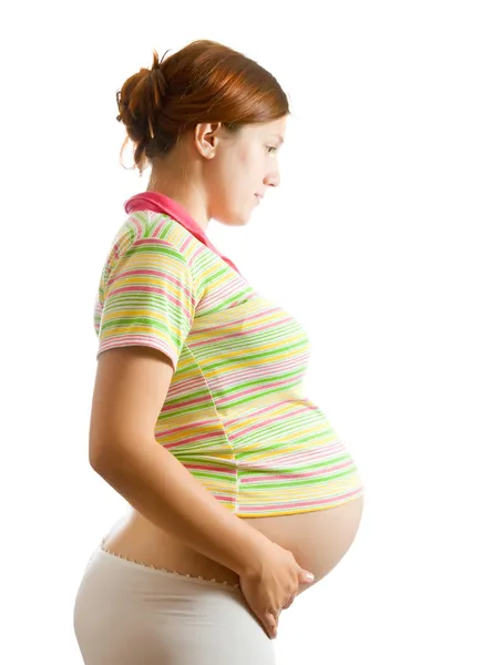 Mujer embarazada sobre blanco Imagen de archivo