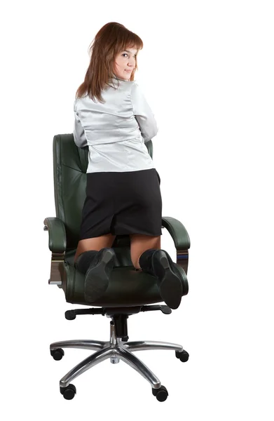 Swoman kneeling on chair — Stock Photo, Image