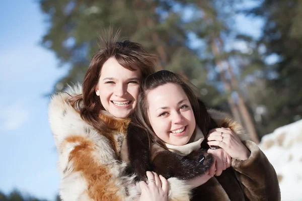 Happy girls in winter park Royalty Free Stock Images