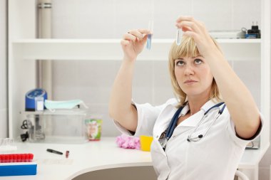 Woman doctor with test tube clipart