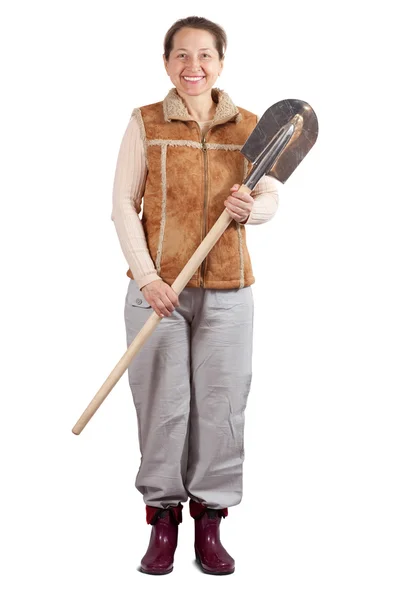 Happy woman stands with spade — Stock Photo, Image