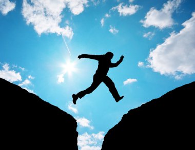 Man jump through the gap. clipart