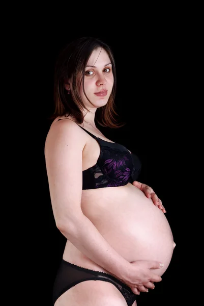 黒の背景に妊娠女性 — ストック写真