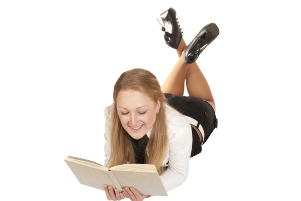 Blond flicka liggande läser en bok — Stockfoto