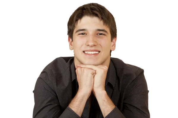 Mladý muž sedí opřený o bradu rukou — Stock fotografie