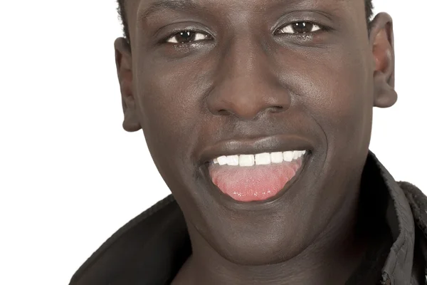 Cara de un joven de piel oscura con la lengua colgando — Foto de Stock