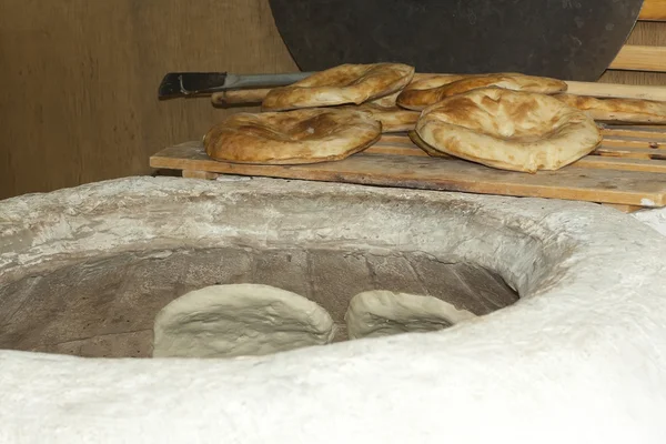 stock image Baking pita bread in a stone oven