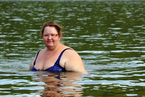 Plump woman bath in river — Stock Photo, Image
