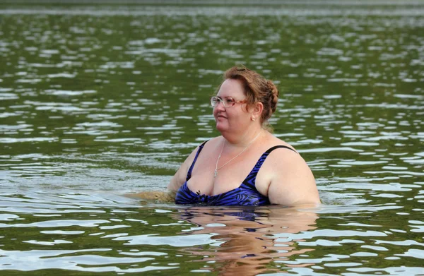 Plump woman bath in river — 스톡 사진