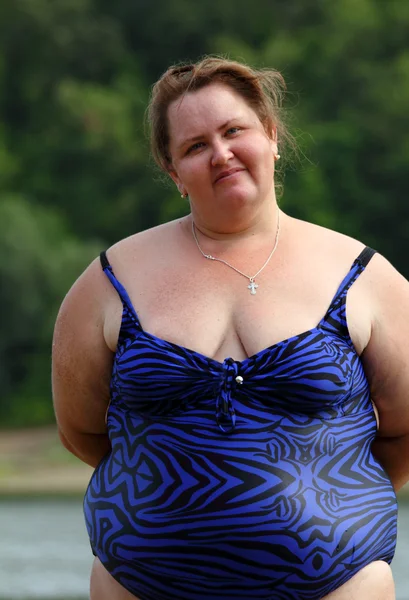 Mulher gorda de pé perto do rio — Fotografia de Stock