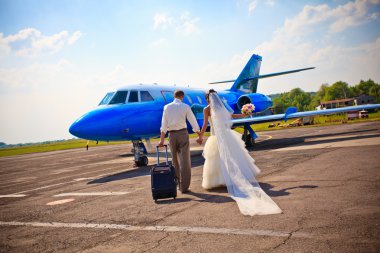 Wedding couple fly on honeymoon clipart