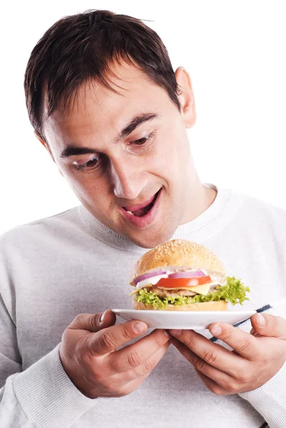 Człowiek ma hamburger na białym tle — Zdjęcie stockowe