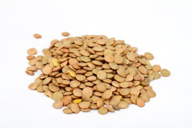 Pile of green lentils from low perspective isolated on white. clipart