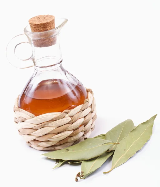 stock image Vinegar bottle and laurel leaf on the white