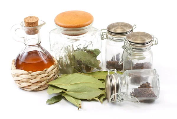 stock image Vinegar bottle, spices and laurel leaf on the white