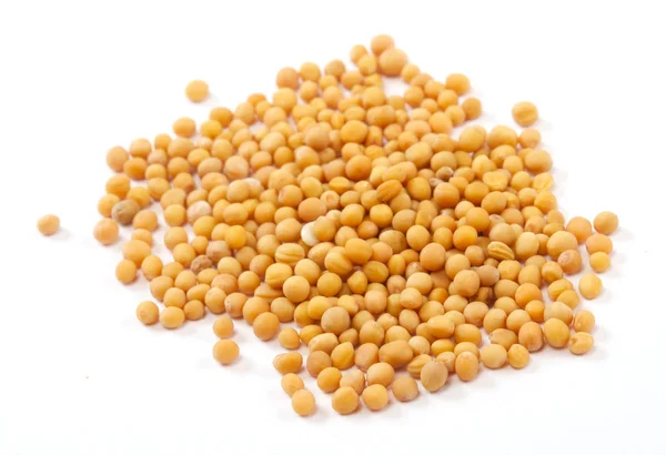 Семена желтой горчицы на белом фоне — стоковое фото