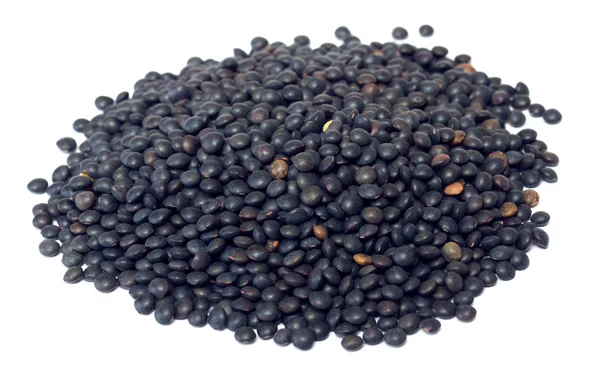 白で隔離される黒いレンズ豆のヒープ — ストック写真