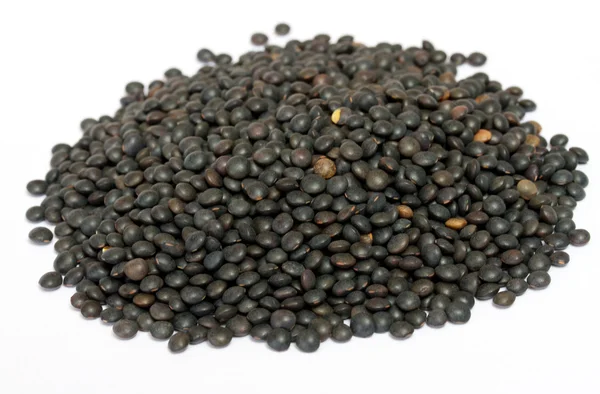 Heap of black lentil isolated on white — Stock Photo, Image