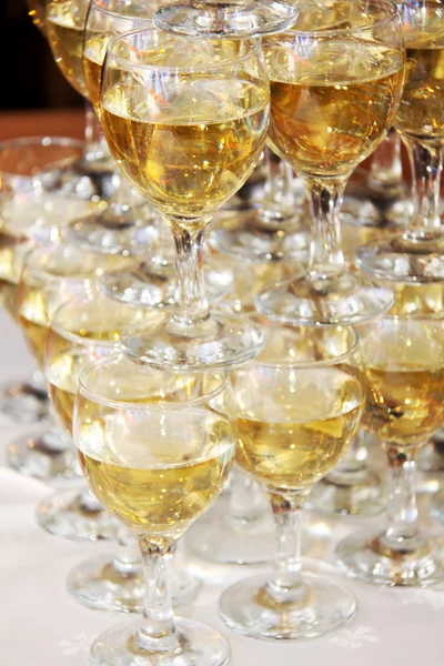 stock image Closeup of white wine glasses in a line