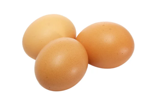 Drie eieren liggen op een wit — Stockfoto