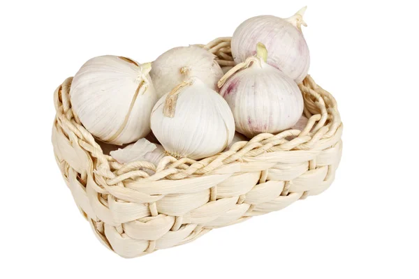 stock image Several garlic onions in a basket isolated