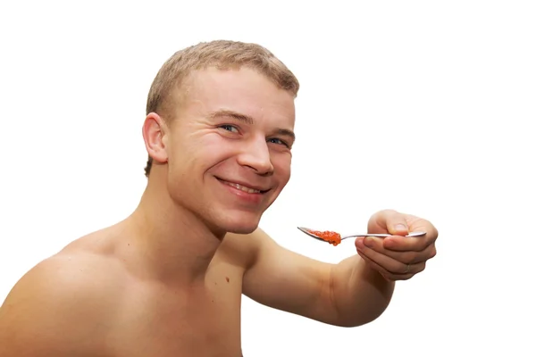 年轻男子吃红鱼子酱 — 图库照片