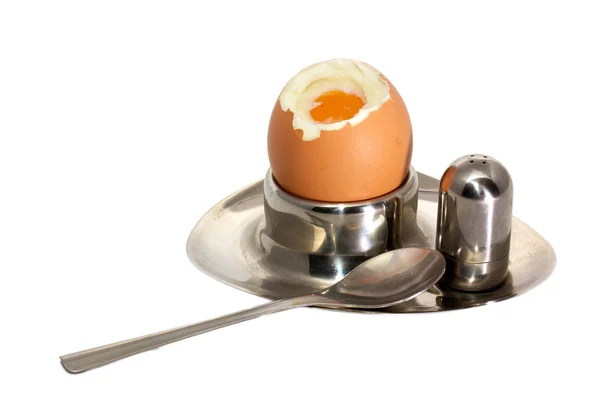 stock image Eggs in eggcups on a tray with saltshaker isolated over white