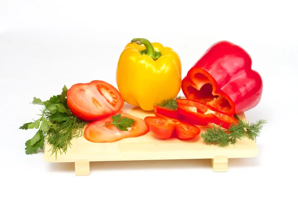 Pepper, tomato with dill and parsley on the wood desk isolated — Stock Photo, Image
