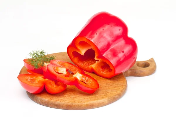 Bright red pepper with dill on the wood desk isolated on white. — Stock Photo, Image