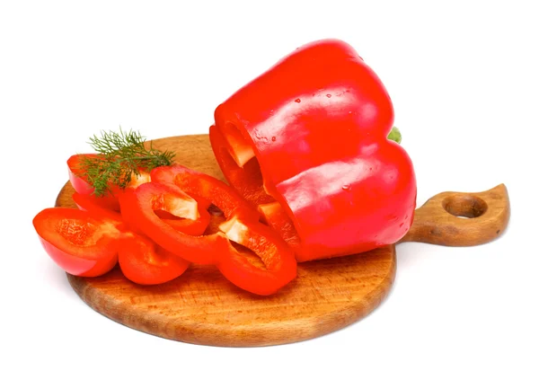 stock image Bright red pepper with dill on the wood desk isolated on white.