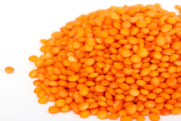 Heap of raw red lentils isolated on white background — Stock Photo, Image