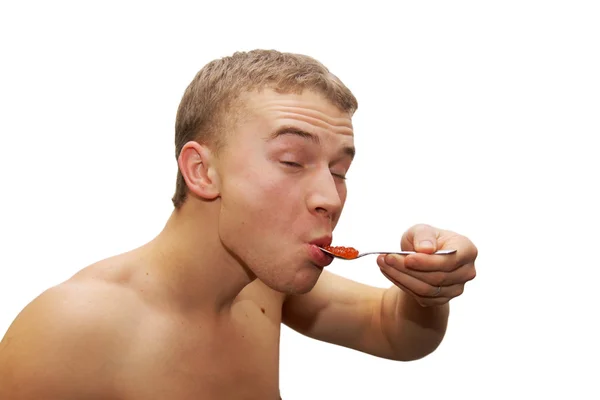 Ung mann som spiser rød kaviar – stockfoto