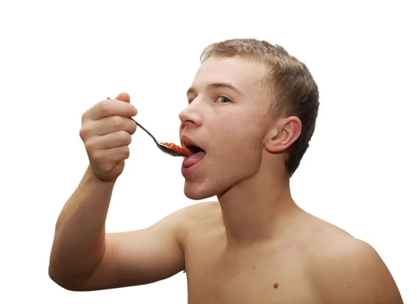 Hombre joven comiendo caviar rojo — Foto de Stock