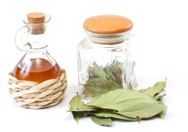 Vinegar bottle and laurel leaf on the white — Stock Photo, Image