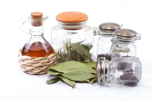 Vinegar bottle, spices and laurel leaf on the white — Stock Photo, Image