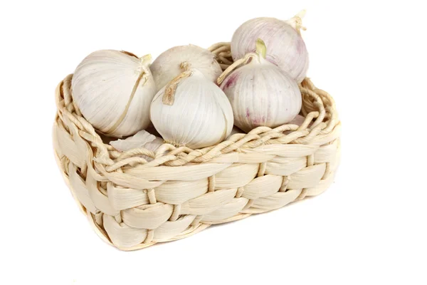 stock image Several garlic onions in a basket isolated