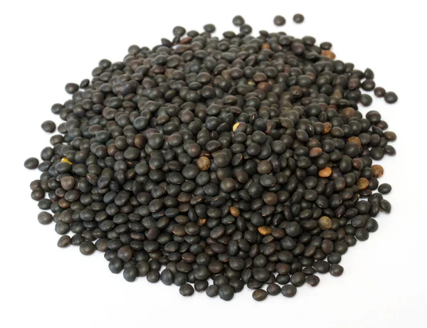 Heap of black lentil isolated on white — Stock Photo, Image
